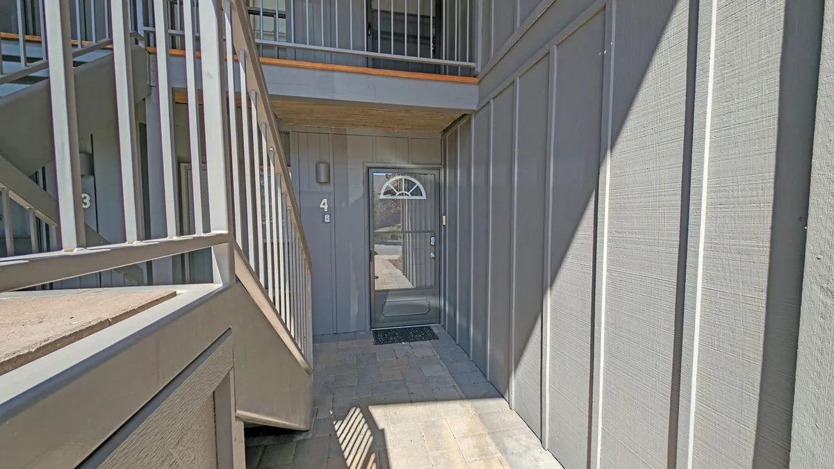 This image showcases the entrance area of the property, featuring a welcoming doorway, visible staircase, and a doormat. The light streaming in and sightlines into the home hint at the ease of coming and going, perfectly suited to guests who want to explore Sunriver's outdoor activities and local attractions.